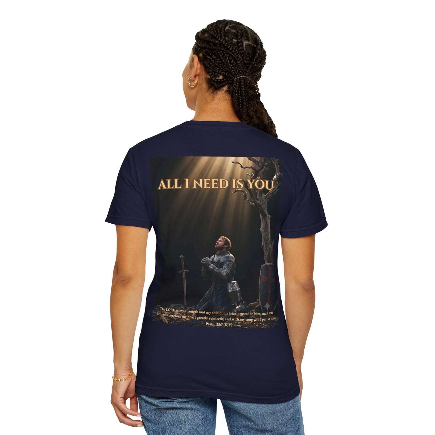 A woman wearing ALL I NEED IS YOU faith tee in True Navy – back view showing a sword of prayer driven into stone and Psalm 28:7 (KJV)